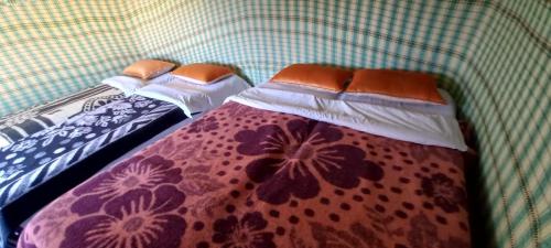two beds sitting next to each other in a room at magical saharain camp in Merzouga