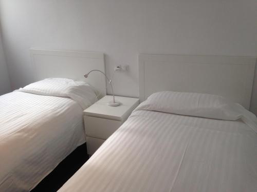 En eller flere senge i et værelse på SI Áticos Puerta del Sol