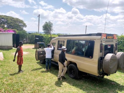 a group of people standing outside of a vehicle at Manyatta Homestay in Sekenani