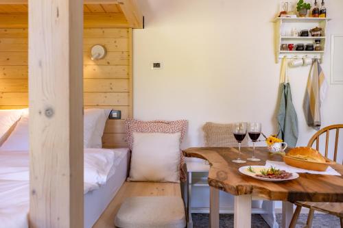 a dining room with a table and a bed at Posestvo Brida - Brkini Hills by the Lakes in Ilirska Bistrica