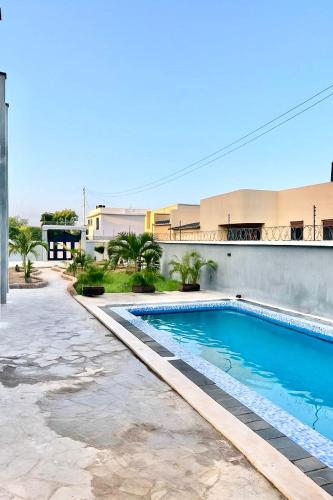 a swimming pool in front of a building at Luxury And Spacious Pool house near the beaches in Diani Beach