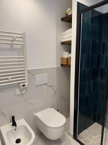 a bathroom with a toilet and a sink and a shower at Cervia Mare in Cervia
