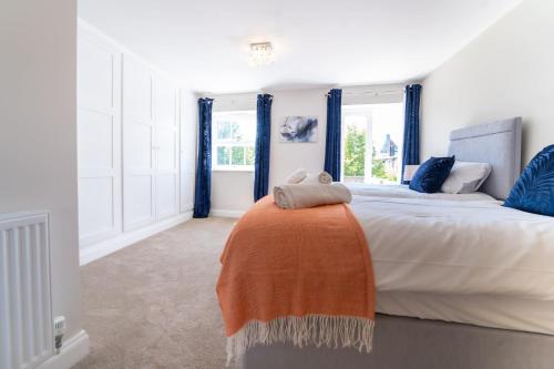 a bedroom with a large bed with blue curtains at King Street Residence - 2 Bed in Great Yarmouth