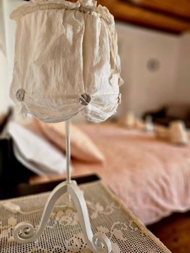 a white lamp sitting on a table in a bedroom at Casa Istriana Center with free parking in Koper