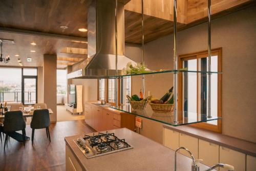 a kitchen with a sink and a stove top oven at Cooee函館byTAKADAYA in Hakodate