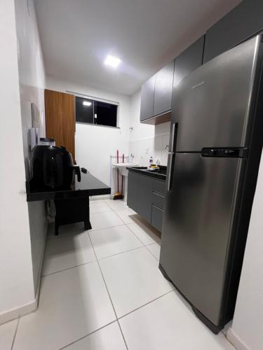 a kitchen with a stainless steel refrigerator at Casa Arruda Climatizado Próx à Shopping Boulevard in Vitória da Conquista