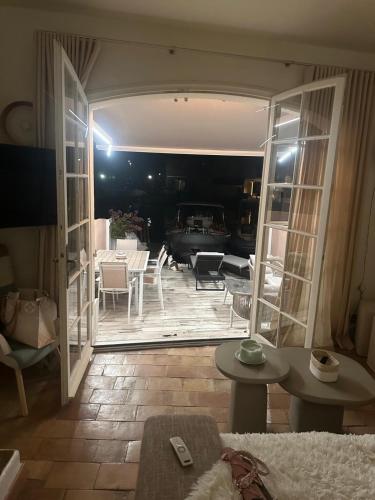 - un salon avec une porte ouverte sur une terrasse dans l'établissement Petite maison de pecheur, à Grimaud