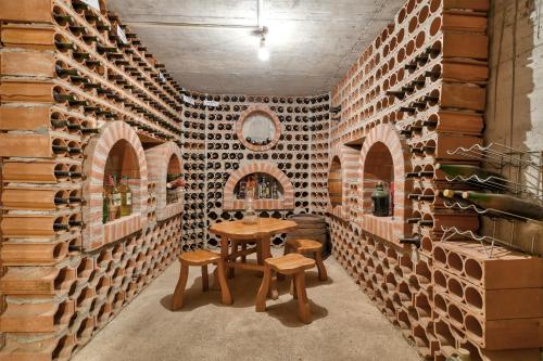 a room with a table and a wall of wine bottles at Sun Guest House in Budva
