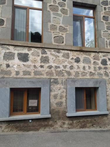 a building with three windows on the side of it at Verishen Guest House B&B in Goris