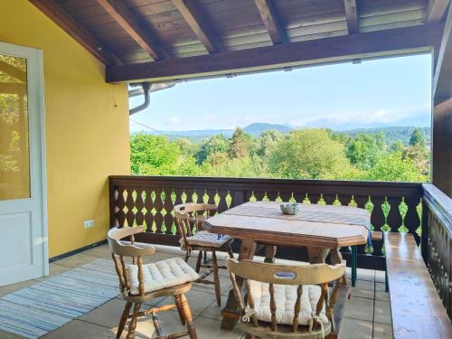 a wooden table and chairs on a balcony at Ferienwohnungen Villa Winkler in Velden am Wörthersee