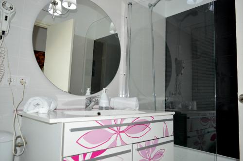 a bathroom with a sink and a mirror at Apartamentos de las Heras in Ibiza Town