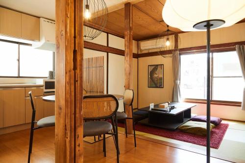 a living room with a table and a dining room at 日進月歩 in Kawasaki