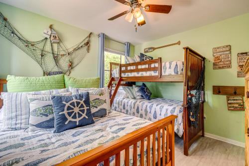 a bedroom with two bunk beds and a ceiling fan at Lakehouse Hot Tub, Waterslide, Game Room and Kayaks in Blanchard