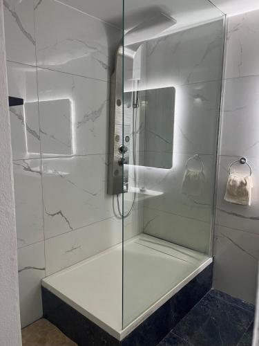 a shower with a glass door in a bathroom at Summer Getaway 3Bed,Private Pool in Xagħra