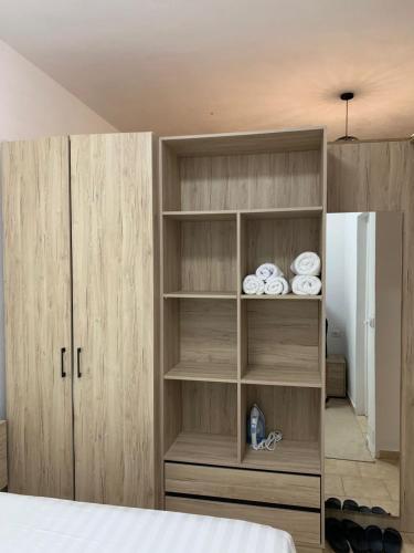 a bedroom with a book shelf with towels at Secret Villa in Vlorë
