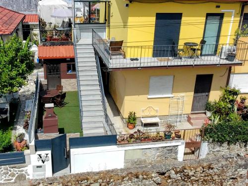 an overhead view of a yellow building with stairs at Vivenda Terinho in Barcelos