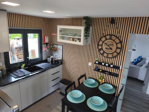 a kitchen with a table with blue plates on it at Vivenda Terinho in Barcelos