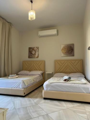 two beds sitting next to each other in a bedroom at Blanca, Marassiمراسي العلمين in El Alamein