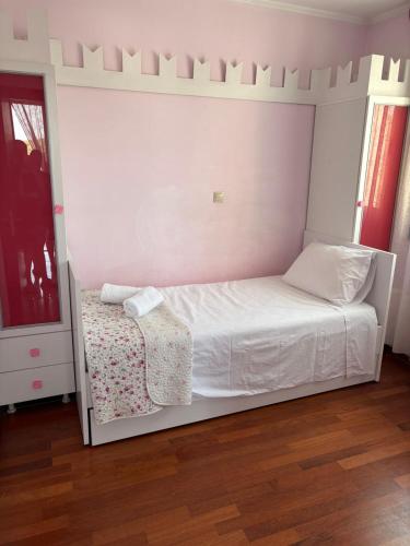 a bedroom with a bed with a white headboard at Casa Maria Tsampika in Psinthos