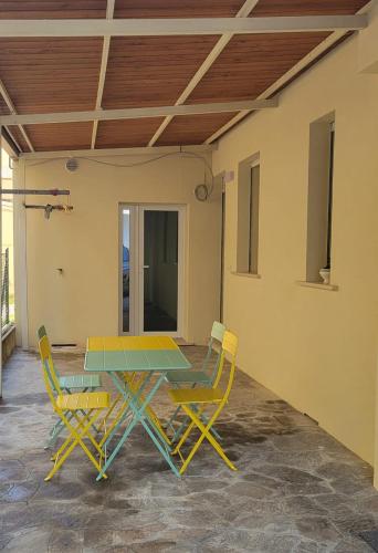 a patio with a table and two chairs at Pixel Sea Home a Misano Brasile 300 m dal mare e free parking, Misano World Circuit a 7 minuti di macchina in Misano Adriatico