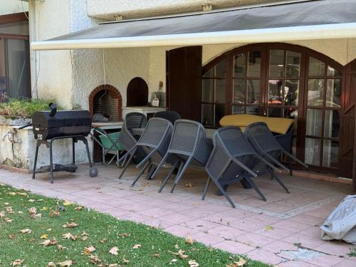 a group of chairs and a grill on a patio at Villa by Lake Sapanca in Sapanca