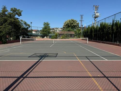 a tennis court with a net on top of it at Villa by Lake Sapanca in Sapanca