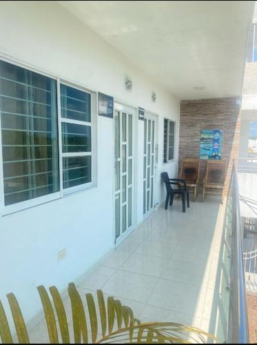 a balcony of a house with a table and chairs at Apartamentos LUISA in Coveñas