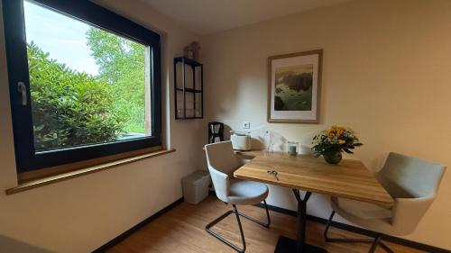 a dining room with a table and a window at Küstenglück in Varel