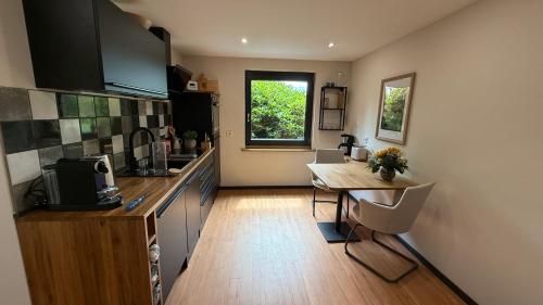 a kitchen with a counter and a table in it at Küstenglück in Varel