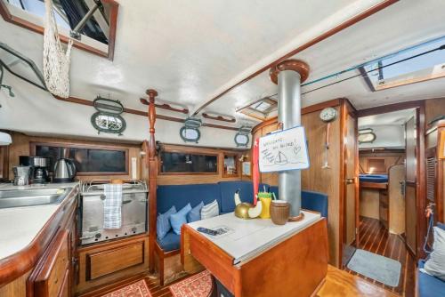 a kitchen with a stove and a table in a boat at Only you onboard - Walk to beach & downtown in Puerto Aventuras
