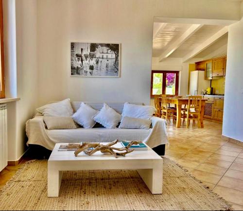 a living room with a couch and a table at Villa INARIME in Ischia