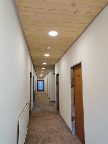 an empty hallway in an office building with a wooden ceiling at Hotel Sonnblick in Kartitsch