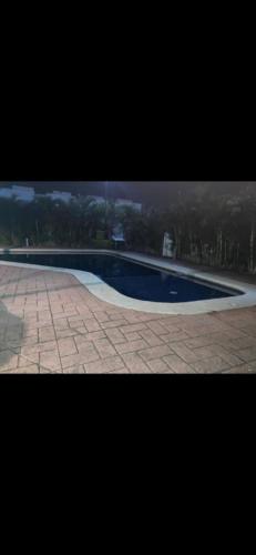 a large swimming pool with a tiled floor and aphalt at Casa Vallarta in Jarretadera
