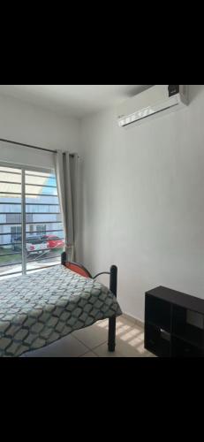 a bedroom with a bed and a large window at Casa Vallarta in Jarretadera