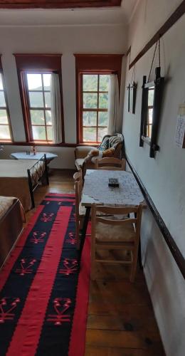 a living room with a table and a couch at Guest House Panorama in Berat