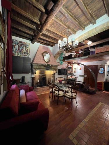 a living room with a couch and a table with chairs at Grand Tour Suite Home in Spoleto