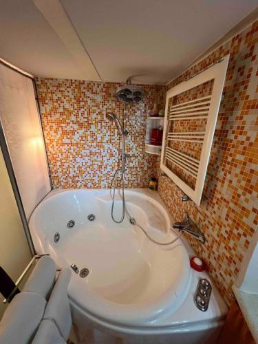 a bathroom with a large tub in a room at Grand Tour Suite Home in Spoleto