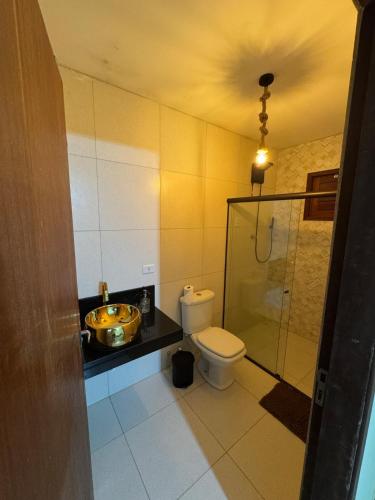 a bathroom with a toilet and a sink and a shower at Casa amarela Serra negra ! in Bezerros