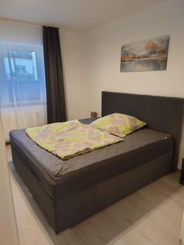a bed in a bedroom with a bed frame and a window at Ferienwohnung Ella in Gries