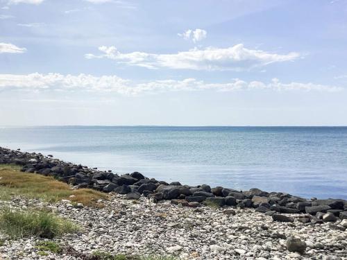 a group of rocks on a beach near the water at 6 person holiday home in Løgstør in Løgstør