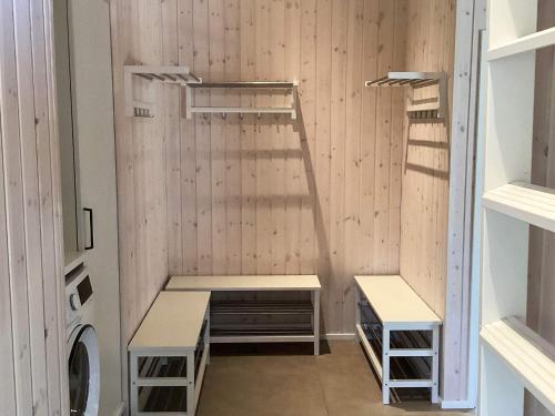 a locker room with two benches and a ladder at 5 star holiday home in Højslev in Højslev