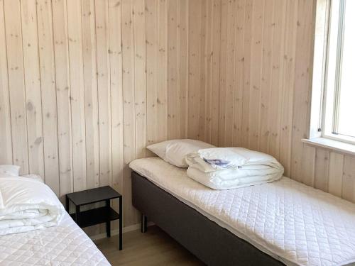 a bedroom with two beds and a window at 5 star holiday home in Højslev in Højslev