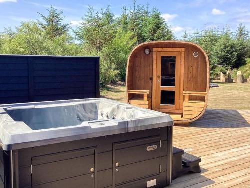 a tub on a deck next to a sauna at 5 star holiday home in Højslev in Højslev