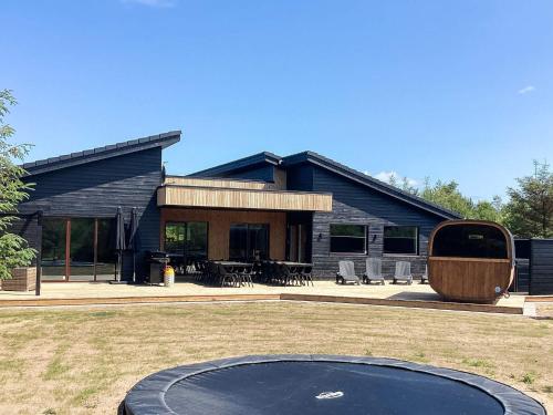 a house with a trampoline in front of it at 5 star holiday home in Højslev in Højslev