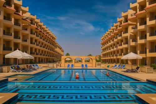 a swimming pool in the middle of a hotel at Selena Bay Luxury Sea View 1BR Apartment, Private Beach and Pool in Hurghada