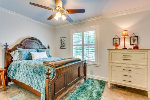 a bedroom with a bed and a ceiling fan at Deck and Gas Grill Riverfront Home in Heber Springs in Heber Springs
