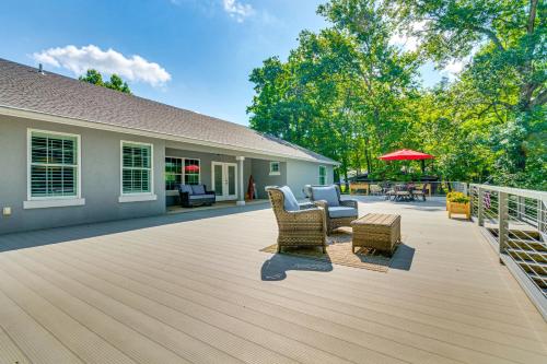 a large deck with furniture and a house at Deck and Gas Grill Riverfront Home in Heber Springs in Heber Springs