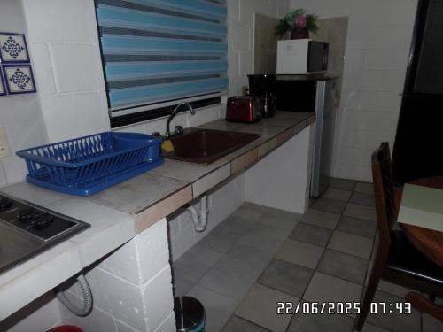 a kitchen with a sink and a counter top at Casita El Zacatal in San José del Cabo