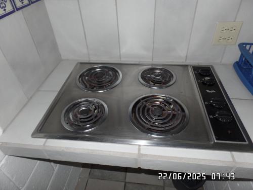 a stove with four burners on a counter in a kitchen at Casita El Zacatal in San José del Cabo