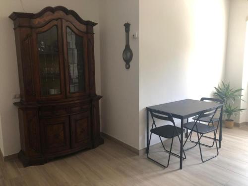 a dining room with a table and chairs and a cabinet at Domus Latina in Rome